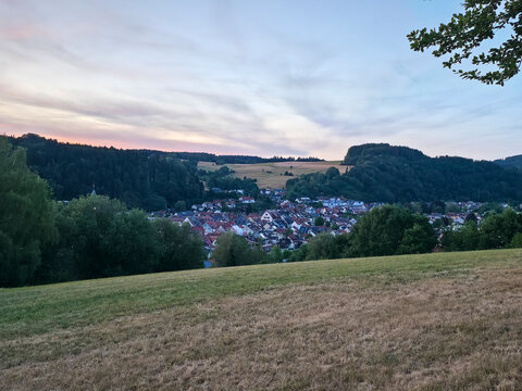 germany, elevated sunset view across charming elzach village roofs with colorful summer atmosphere and breathtaking schwarzwald mountain landscape beyond