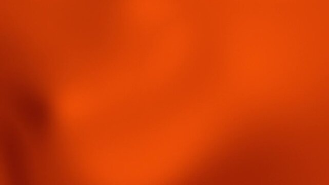 Abstract vibrant red and orange gradient background with soft fluid motion