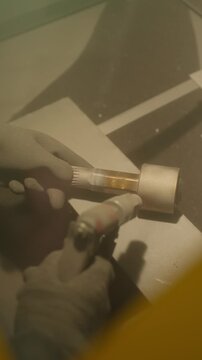 Worker performs precision sandblasting of a metal product. Metal product manufacturing concept.