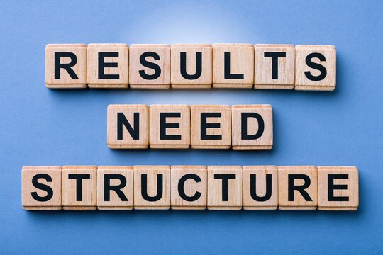Results need structure phrase made of wooden letter tiles on blue background