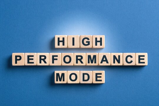High performance mode phrase made of wooden letter tiles on blue background