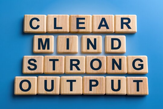 Clear mind strong output phrase made of wooden letter tiles on blue background