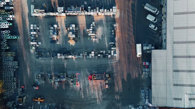 Aerial view of industrial yard with parked vehicles. Industrial chemical plant