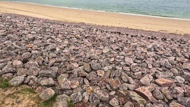 Coastal Stone Protection Against Beach Erosion.
Large stone barriers line the shoreline to reduce coastal erosion and protect beaches from the impact of waves, storms, and rising sea levels. These eng