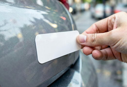 Black rectangle car sticker mockup applied to vehicle body, ai generated. Adhesive tag glued to automobile body by hand. Clean vinyl decal for custom branding, company logos, promotional graphics.