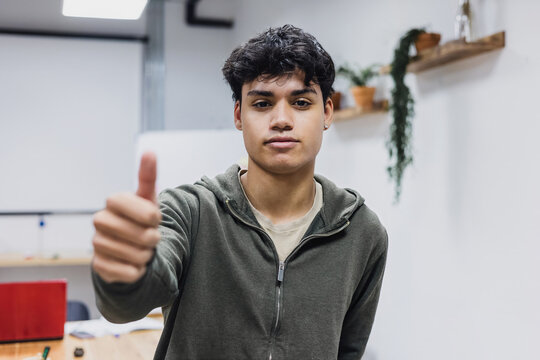 portrait of young latin man student with point finger in Latin America