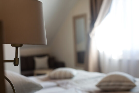 Cozy hotel room with soft bedding and natural light from window