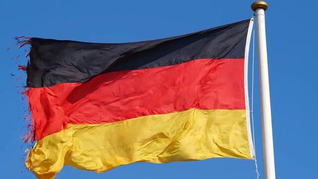 German flag waving against a clear blue sky