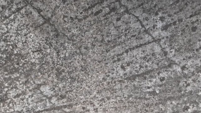 Close up shot of old weathered concrete surface with cracks and grunge texture for background.
