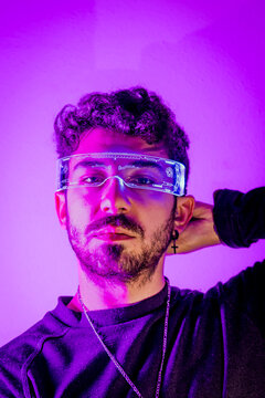 Man wearing technologically advanced glasses in cyberpunk neon light