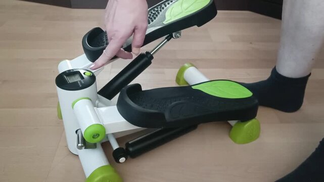 Side angle shot of mini stepper with ergonomic handlebars and non-slip pedals, showcasing stability features for safe home workouts.
