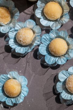 Sweet treats are arranged on a serving tray at a festive gathering with brigadeiro as the main dessert