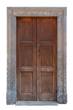 Old traditional European entrance featuring weathered brown wooden double doors with rectangular panels and a vintage metal handle, framed by classic rustic grey stone portal and threshold,  isolated 
