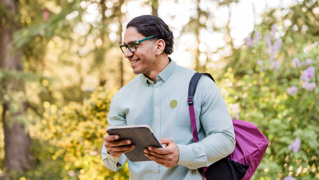 Latino man with disability studying at university outdoors