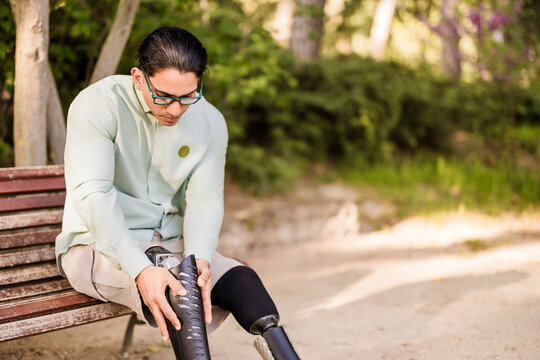 Latino man with prosthetic legs preparing for work
