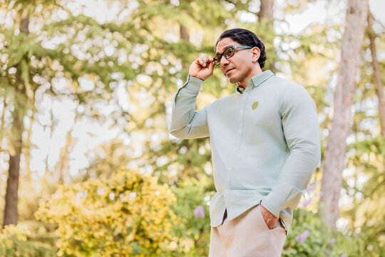 Latino man with disability looking thoughtful in park
