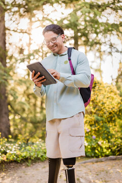 Latino man with prosthetic leg studying outdoors