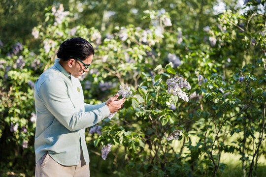 Latino biologist observing plant growth studying ecology