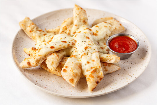 Brick oven bread sticks with ketchup in a light environment