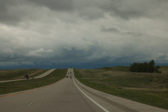 Stormy Sky Over Empty Highway Through Rolling Plains