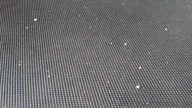 Textured black rubber surface moving in a smooth digital motion clip