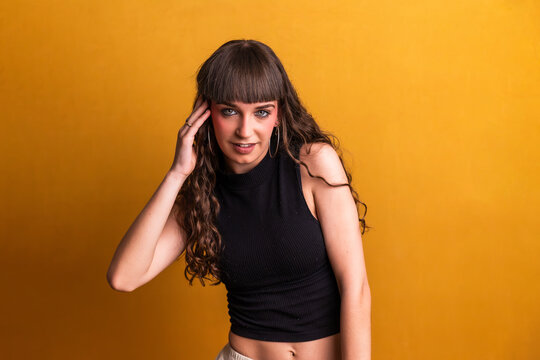 Young woman dancer performing expressive studio movements