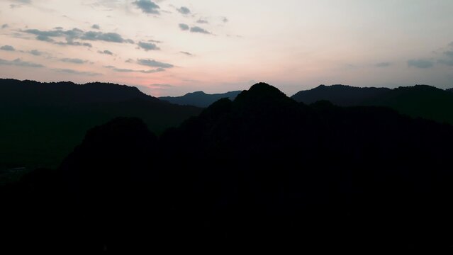 Khao sok national park landscape with dark mountains silhouetted at sunset