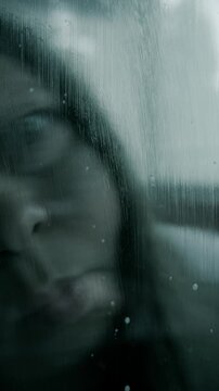 chilling blurry face, Terrified woman screaming behind wet glass, Panic and horror, violence, nightmares, halloween, intense fear, entrapment mental anguish, vertical Mysterious Psychological thriller