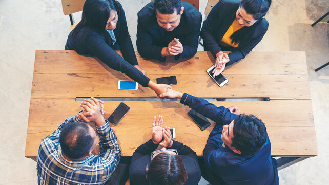 Top view of MultiEthnics Teamwork high five hands stack shakehand together. Collaboration Team Meeting in Conference Room. Diversity Partner Business Meeting brainstorm hand holding teamwork consult