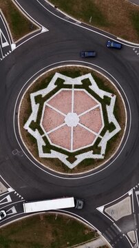 Vertical Drone Shot, Roundabout Traffic With Star Shape Inside Central Circle, Birdseye Aerial View