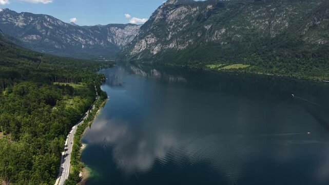 Stunning Lake Bohinj, Slovenia. Drone Shot of Blue Alpine Water, Coastal Road and Hills of Julian Alps