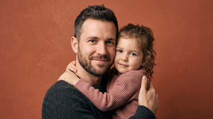 Fototapeta premium Father holding his young daughter in a warm embrace against a textured background