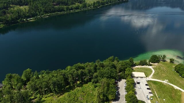 Drone Shot of Lake Bohinj, Slovenia. Lakeside Landscape and Calm Blue Apine Water on Sunny Summer Day
