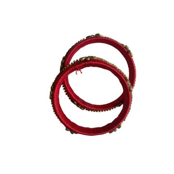 Two traditional red indian bangles with golden embellishments isolated on a transparent background