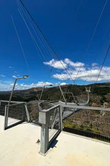 Arouca 516 suspension bridge crossing a dramatic valley in Portugal, showcasing modern engineering, adventure tourism, geometric design, scenic landscapes, and outdoor exploration © esvetleishaya