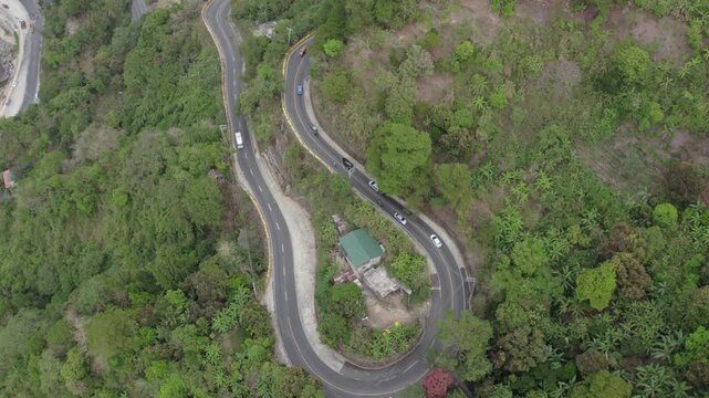Forward Tracking High-Angle Aerial View of Traffic on Winding Kennon Road, Philippines