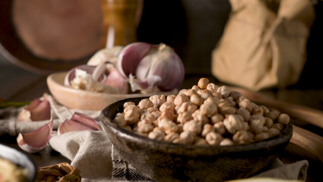 Bowl of raw chickpeas with fresh garlic cloves