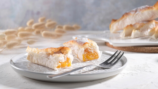 Golden phyllo pastry filled with fruit on a plate