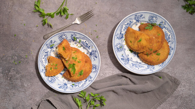 Golden fried rissoles served on vintage blue and white patterned plates