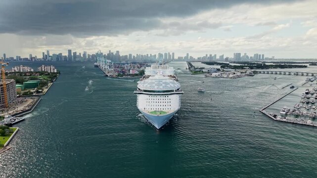 Aerial drone view of luxury liner. Ship leaving Miami beach port. Cruise ship vacation, 4k. Aerial view of cruise ship in vacation summer. Cruise ship vacation and travel at sea
