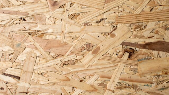 Close up view of light brown wooden chipboard texture