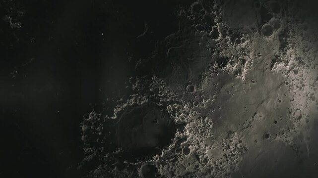 Detailed lunar surface terrain featuring craters in a cinematic high quality space exploration motion video clip