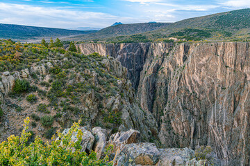 Sheer dark schist canyon walls plunge into the narrow gorge with Painted Wall pegmatite streaks visible, Black Canyon of the Gunnison NP, Colorado. © ZL Visuals