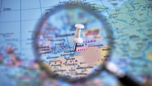 Close up of a magnifying glass over a map highlighting Klaipeda