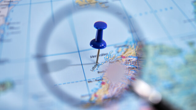 The paper map shows a close-up of Lofoten, marked with a blue pin.