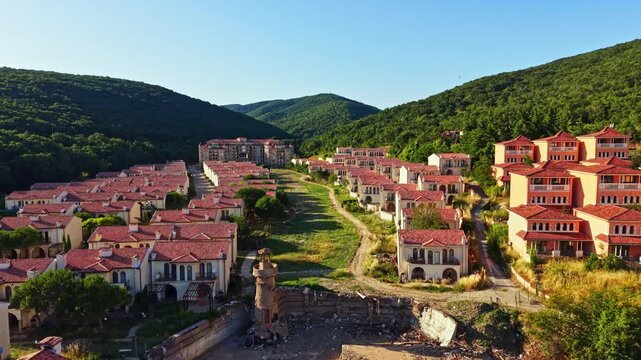 Elenite city has water damage with many buildings affected. Parts of the city are empty. Green areas are visible alongside ruined structures and scattered debris from the flood.