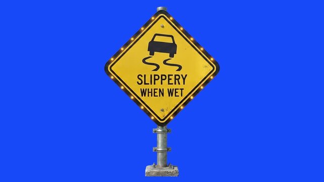 A yellow diamond-shaped warning sign with a car skidding icon and the text "Slippery When Wet", mounted on a metal post against a solid blue screen background. This 3D asset is ideal for road safety v