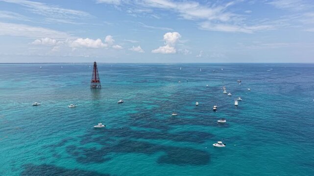 Boats anchored off Sombrero Key Reef Lighthouse near Marathon in the Florida Keys.