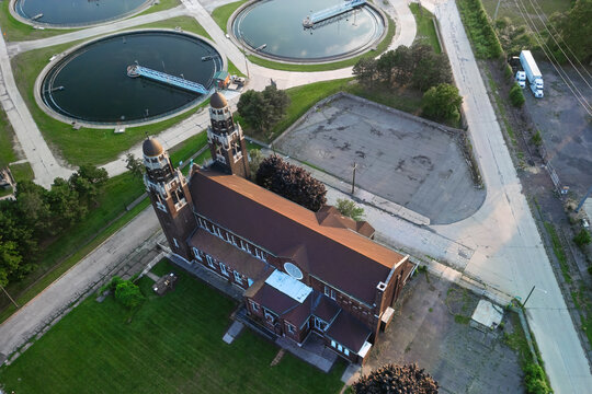 Church next to wastewater treatment plant aerial view