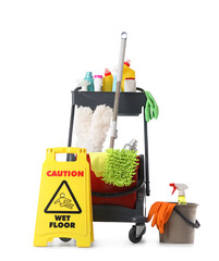 Naklejka premium Professional cleaning service cart with various supplies and a yellow wet floor sign, isolated on a white background, a professional cleaning service cart is equipped with various cleaning supplies